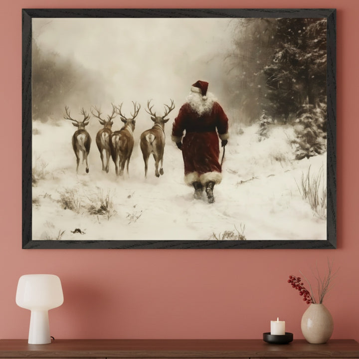 Contemporary living room with a dark wooden console table against a peach wall. A large framed print of Santa Claus leading five reindeer through a snowy, foggy landscape in a vintage painting style hangs above.