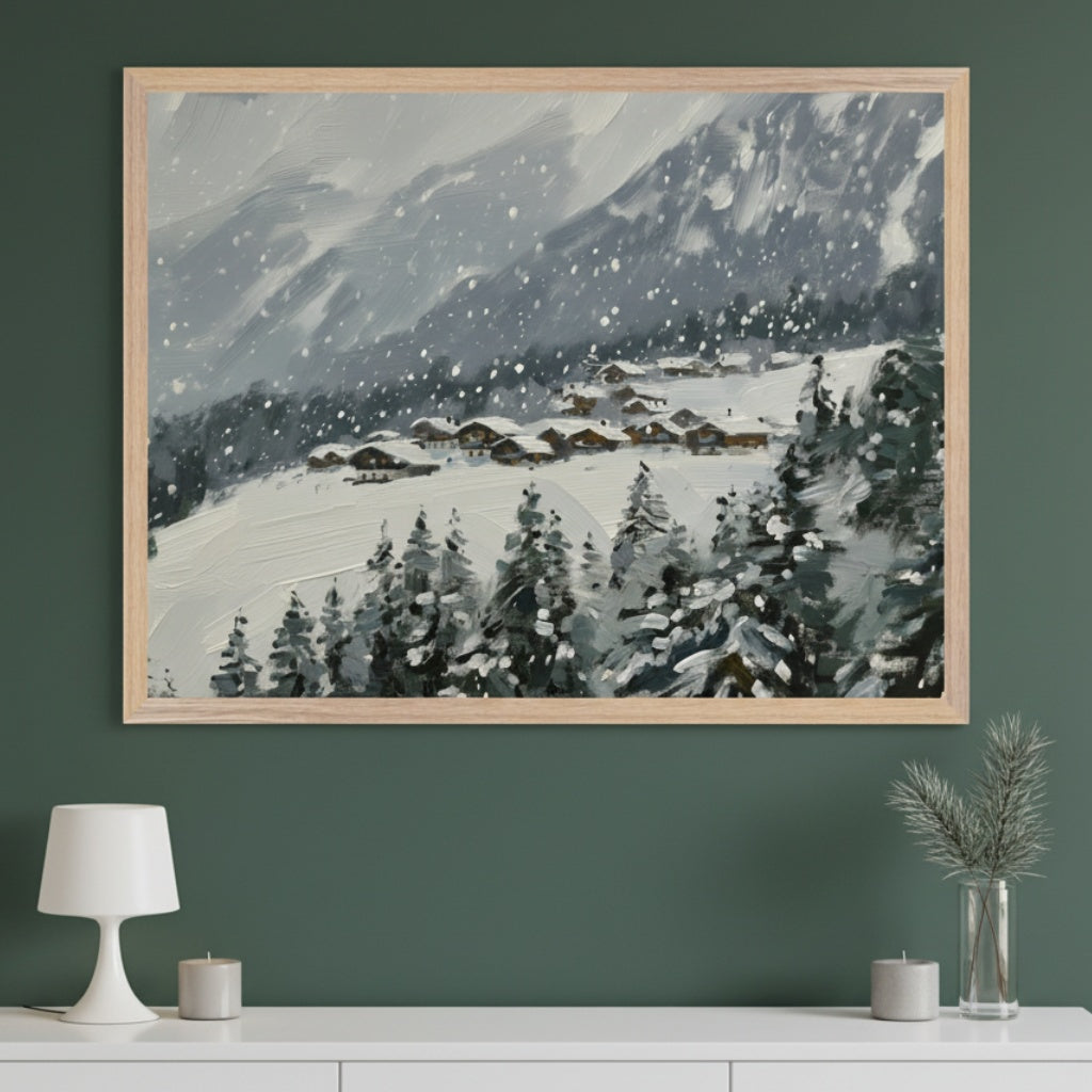 Modern room with a dark green wall. A large framed painting depicting a snowy mountain village, pine trees, and falling snow hangs centrally above a white console table. A white lamp, candles, and a plant are on the table.
