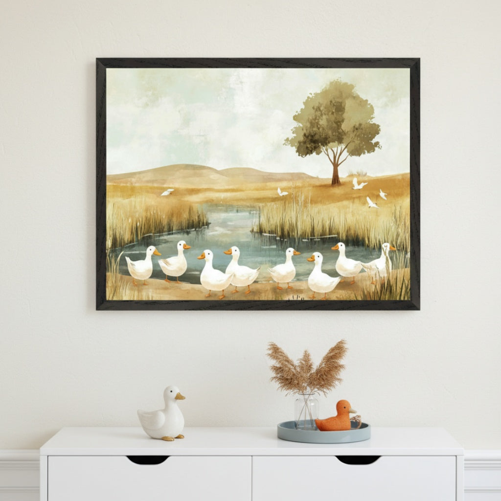 Modern room with a white dresser. A large framed painting of nine white ducks by a pond in a golden grassy landscape with a tree hangs centered above it. The art is in a gentle, illustrative style. A white duck figurine sits on the dresser.