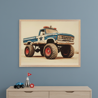 Kid's bedroom with a light wood dresser against a blue wall. A large framed print of a blue and white vintage police monster truck, in an illustrative style, hangs centered above the dresser. Small monster truck toy and red star decorations are on the dresser.