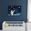 Modern nursery with a white crib and dresser against a dark blue wall. Above the crib hangs a framed illustration of an astronaut collecting glowing stars in a jar. A golden rocket sits on the dresser.
