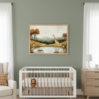 Modern nursery with a sage green wall. A large framed print of a giraffe by a pond in a safari-themed illustration style hangs above a white and wood crib. A light wood dresser and cream armchair are also visible.