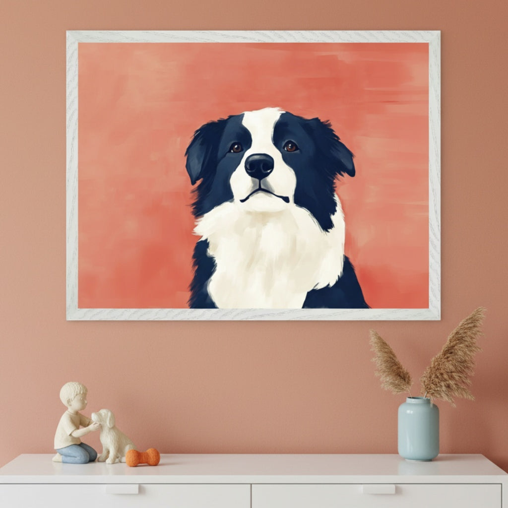 Modern room with a peach wall and a white dresser. A large framed painting of a black and white Border Collie dog in a painterly style hangs above the dresser. Figurines of a boy, a dog, an orange bone, and a vase with pampas grass are on the dresser.