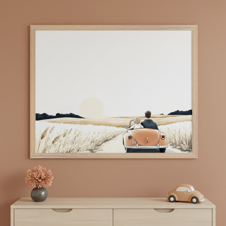 Modern child's room with a light wood dresser. A framed illustration hangs centered above, showing a father and child in an orange convertible driving through a wheat field at sunset. A vase with a dried flower and a matching toy car sit on the dresser.