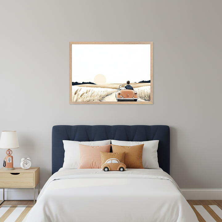 Modern bedroom with a dark blue upholstered bed and light wood nightstand. A framed illustration of a couple in an orange convertible driving on a dirt road through a field at sunset hangs centered above the bed.