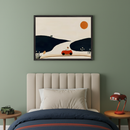 Kid's bedroom with a beige channel-tufted bed and dark blue bedding. A large framed minimalist landscape art hangs centered above the bed, depicting a red car on a road winding through dark hills under an orange sun. Wooden side tables flank the bed.