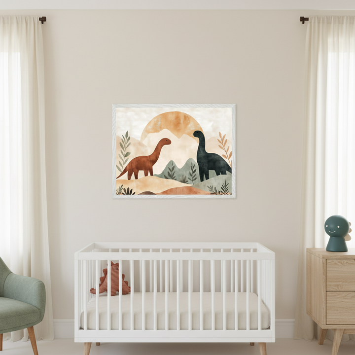 Modern nursery with a white crib. A framed boho print of a brown and dark green dinosaur in a landscape with hills and sun hangs centered above the crib. A wooden dresser is on the right and a green armchair on the left.