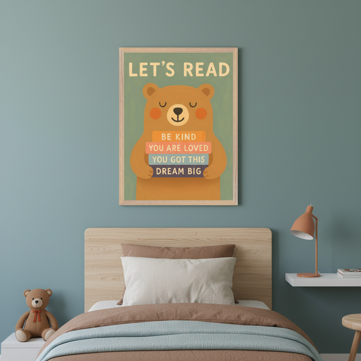 Kid's bedroom with a bed and light wood headboard. A framed poster showing a cartoon bear holding books with "LET'S READ", "BE KIND", "YOU ARE LOVED", "YOU GOT THIS", "DREAM BIG" hangs above the bed on a blue wall. A teddy bear is on a nightstand, and an orange lamp is on a floating shelf.
