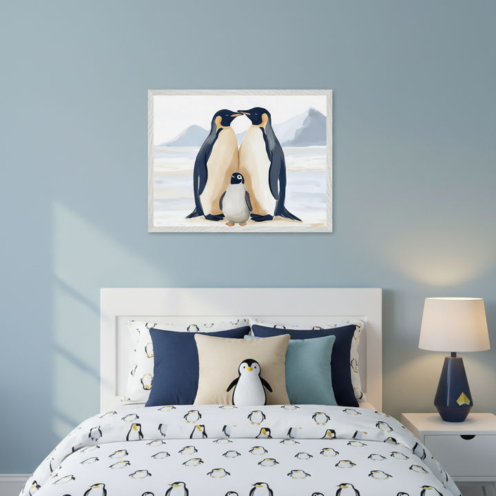 Kid's bedroom with a white bed featuring penguin-patterned bedding. A framed illustration depicting two adult penguins and a chick on ice hangs centered above the headboard. A nightstand with a lamp sits to the right of the bed.