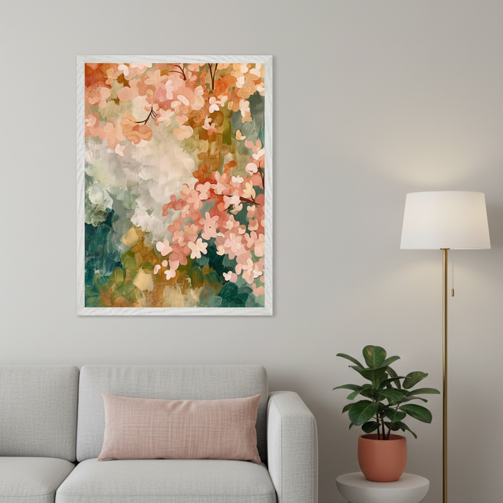 Living room with a gray sofa and pink pillow. A large framed abstract painting of pink and orange flowers with green and brown brushstrokes hangs above the sofa. A brass floor lamp and a potted plant on a white table are on the right.