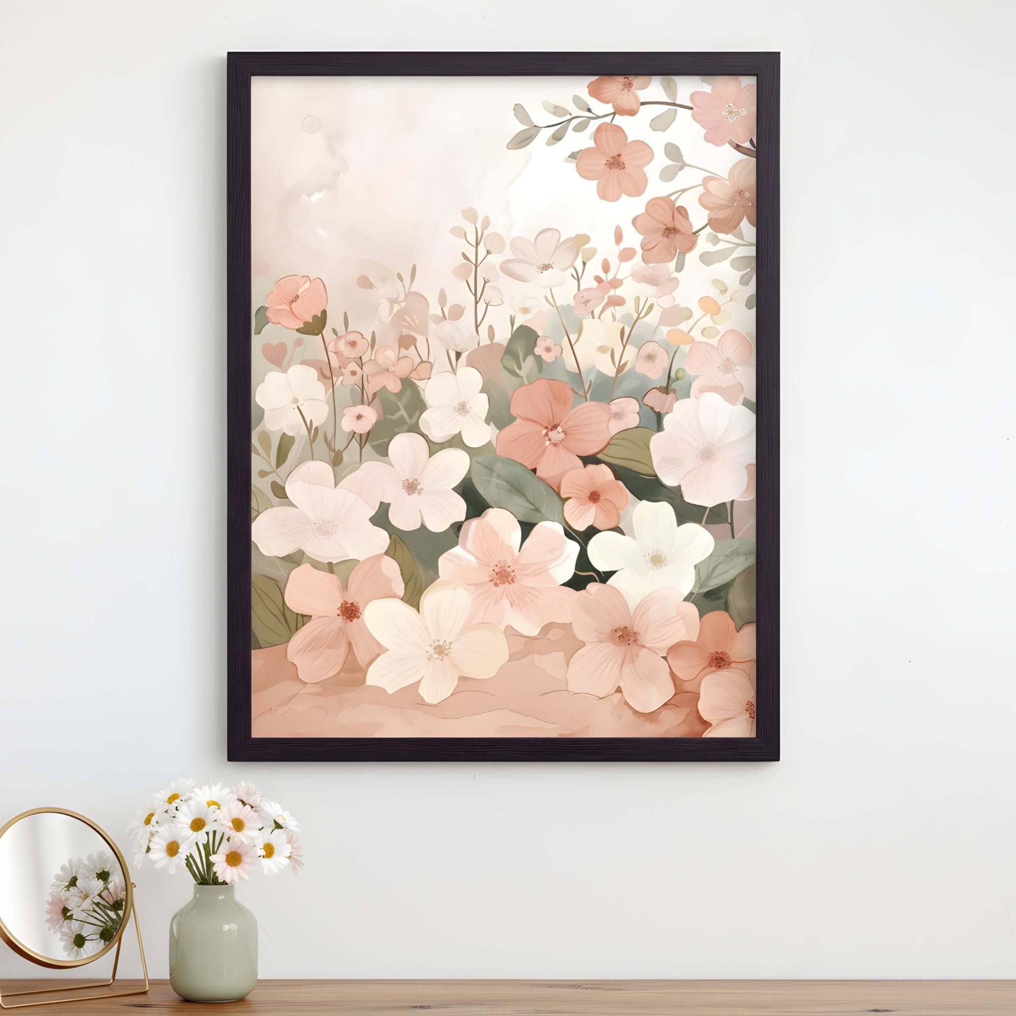 A framed illustration of soft pastel flowers in shades of blush, cream, and peach blooming in a dense garden scene with delicate green leaves. The floral artwork hangs above a wooden surface decorated with a vase of fresh daisies and a small round mirror, adding a light and calming touch to the space.