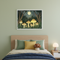 Modern bedroom with a wooden bed and headboard, green and yellow pillows, and a mushroom plush. A framed illustration of glowing mushrooms in a dark forest under a full moon hangs centered above the bed. A lamp sits on a nightstand.