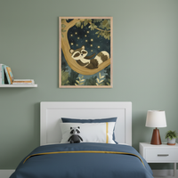 Kid's bedroom with a white bed and headboard against a green wall. Framed art of a raccoon sleeping on a tree branch under a starry night sky hangs centered above the bed. A white floating shelf with books is left, and a nightstand with a lamp and plant is right.