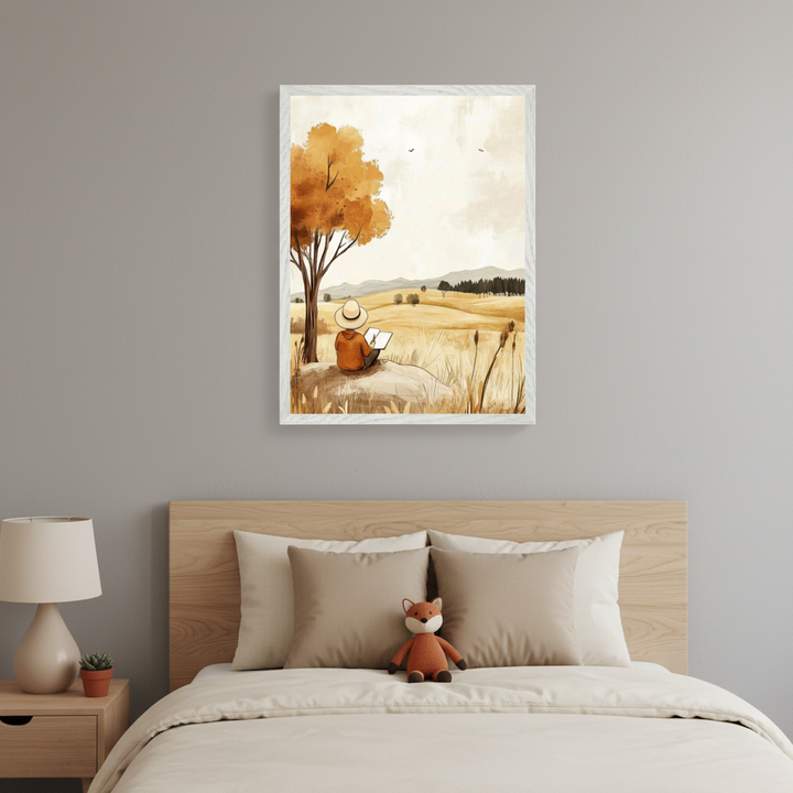 Modern bedroom with a wooden bed, light bedding, and a nightstand. A framed watercolor painting of a person reading under an autumn tree in a golden field hangs centered above the bed.