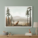 Framed wall art featuring an illustrated fox sitting in a serene forest clearing with pine trees and soft, misty mountains in the background. Below the artwork, a wooden dresser displays a fox figurine, a neutral lamp, and a felt basket with pastel wooden blocks, all set against a muted sage green wall.