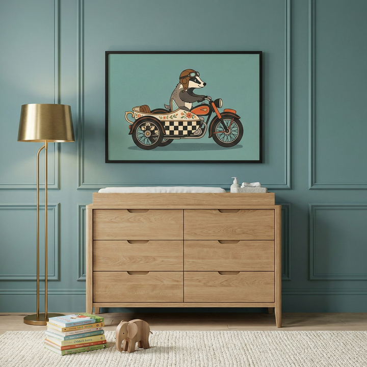 Whimsical badger riding a motorcycle with a sidecar wall art hanging above a light wood dresser in an elegant nursery.