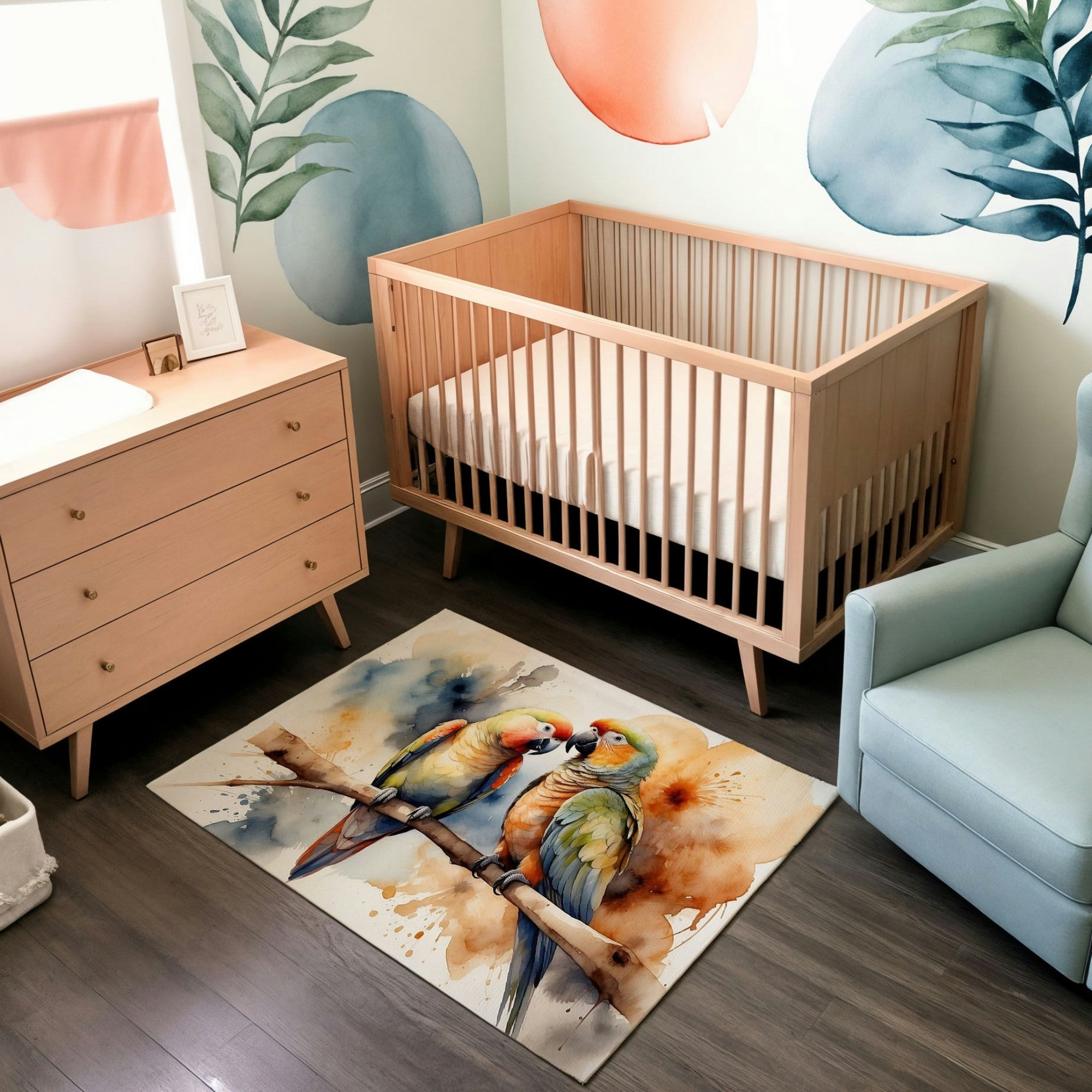 A modern nursery featuring a natural wood crib and dresser, set against walls with artistic watercolor-style murals of leaves and abstract circles in soft orange and blue tones. The room includes a pale blue armchair and sleek wood flooring. The centerpiece is a watercolor-style rug depicting two vibrant parrots perched on a branch, their feathers in shades of green, blue, yellow, and red, adding a lively and tropical feel to the space.