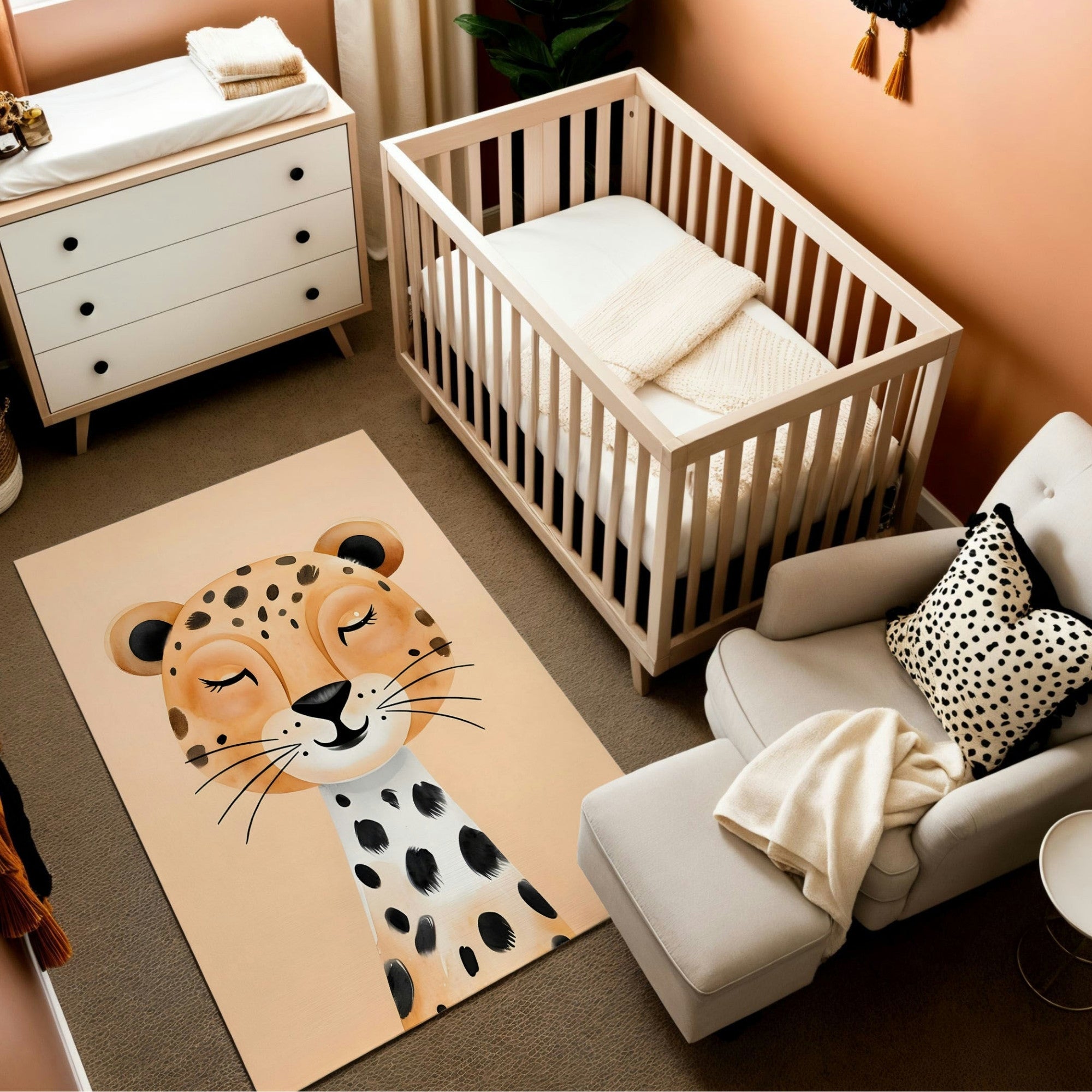 This nursery features a playful safari-inspired design with a warm orange and beige color palette. A light wooden crib is paired with a white dresser and a cozy armchair accented with a spotted throw pillow and blanket. The centerpiece is a charming rug featuring a cheerful leopard illustration with closed eyes and a soft smile. Natural decor elements like plants and warm lighting complete the inviting and whimsical space.