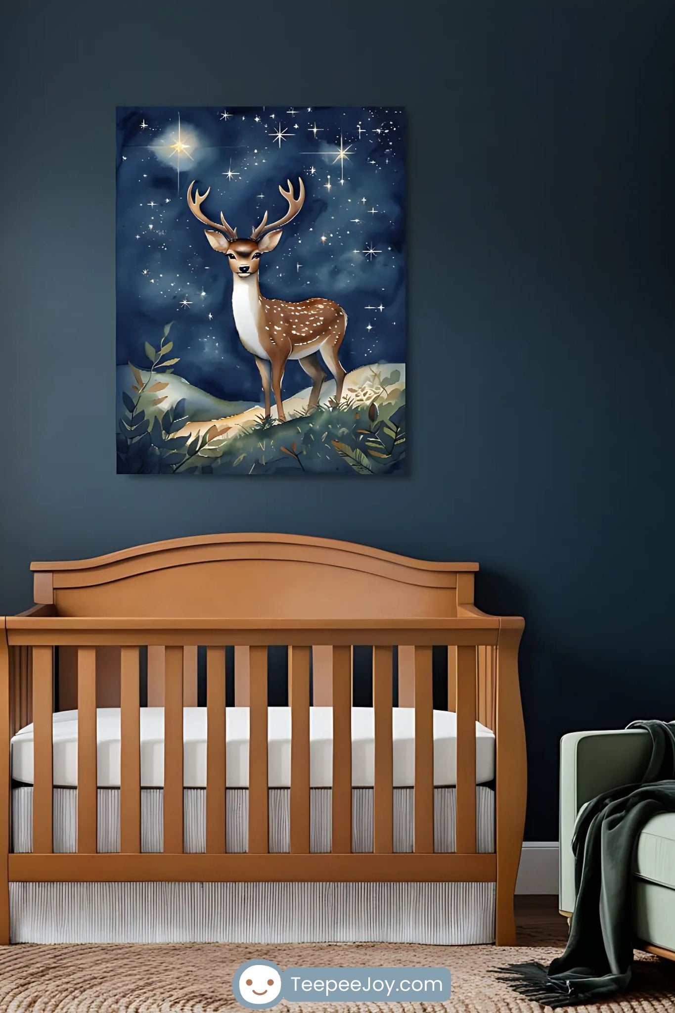 This image features a woodland-themed nursery with dark teal walls and a warm, natural ambiance. A wooden crib sits beneath a framed illustration of a deer with antlers, standing under a star-filled night sky. The room includes a circular jute rug, a light green armchair with a cozy throw, and white curtains, complemented by delicate wall decals of leafy branches, creating a serene and enchanting atmosphere.