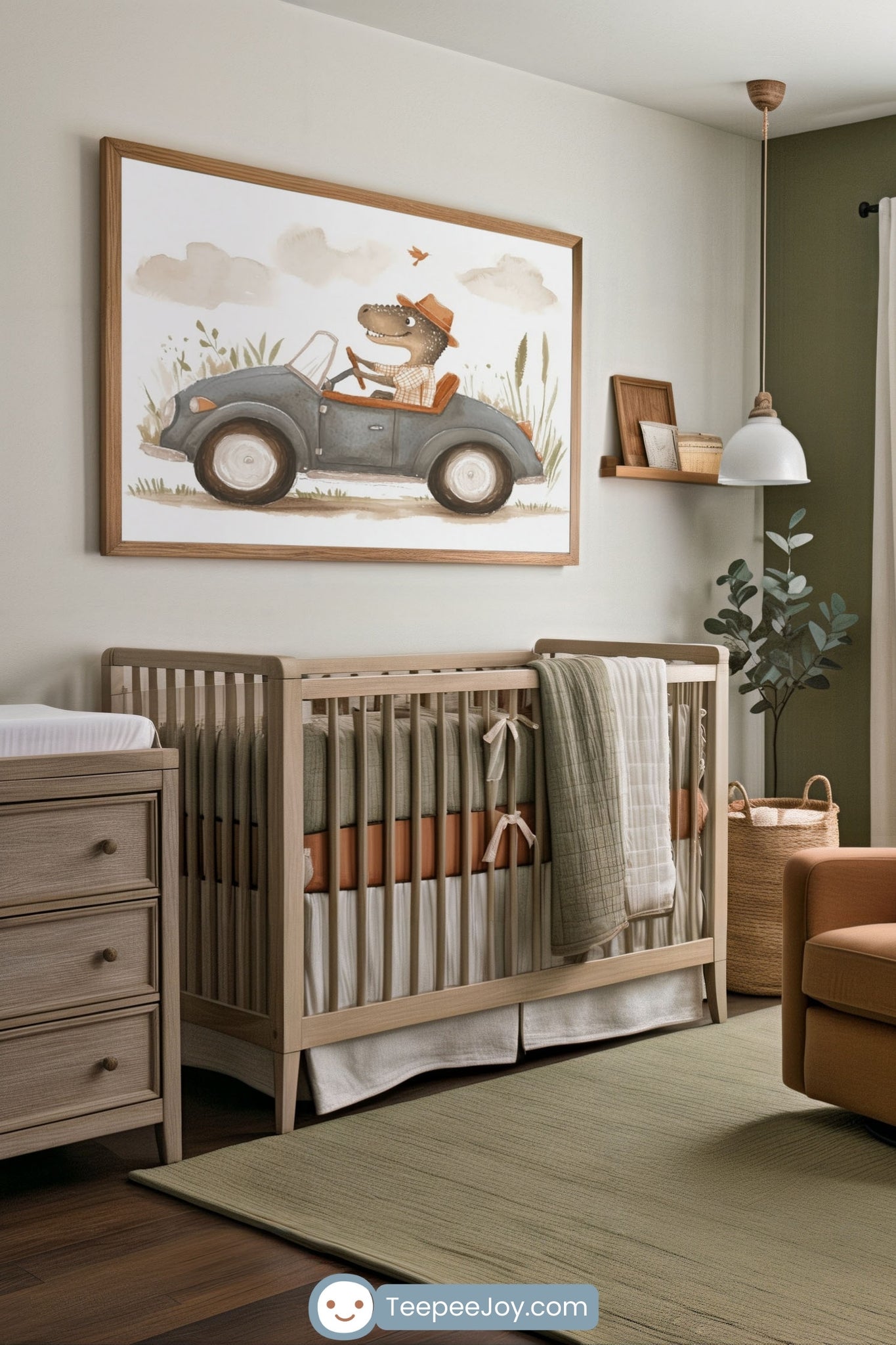 Neutral-toned nursery with a modern, earthy feel, featuring a light wood crib with green and rust bedding. Above the crib hangs a playful framed illustration of a dinosaur wearing a hat and driving a vintage-style car through grassy scenery. The space is styled with a wood dresser, soft green rug, and minimalist shelf decor, blending natural textures and tones.