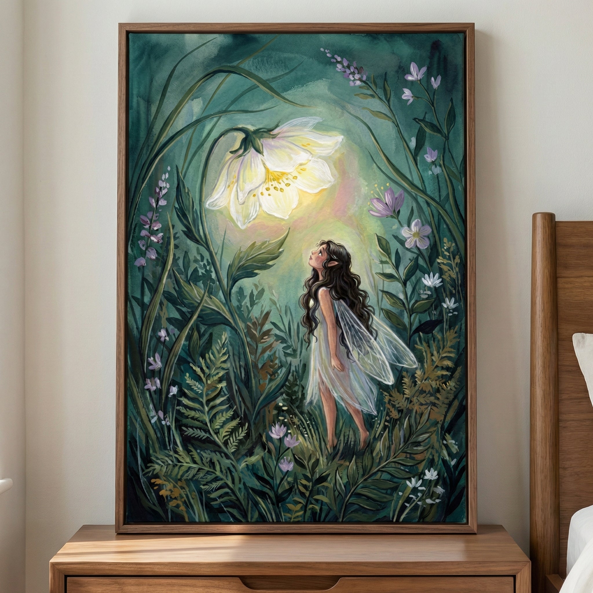 A framed watercolor-style illustration of a fairy with long dark hair and translucent wings standing in lush green foliage, gazing up at a softly glowing white flower, surrounded by delicate leaves and small blossoms that create a calm, magical woodland atmosphere.