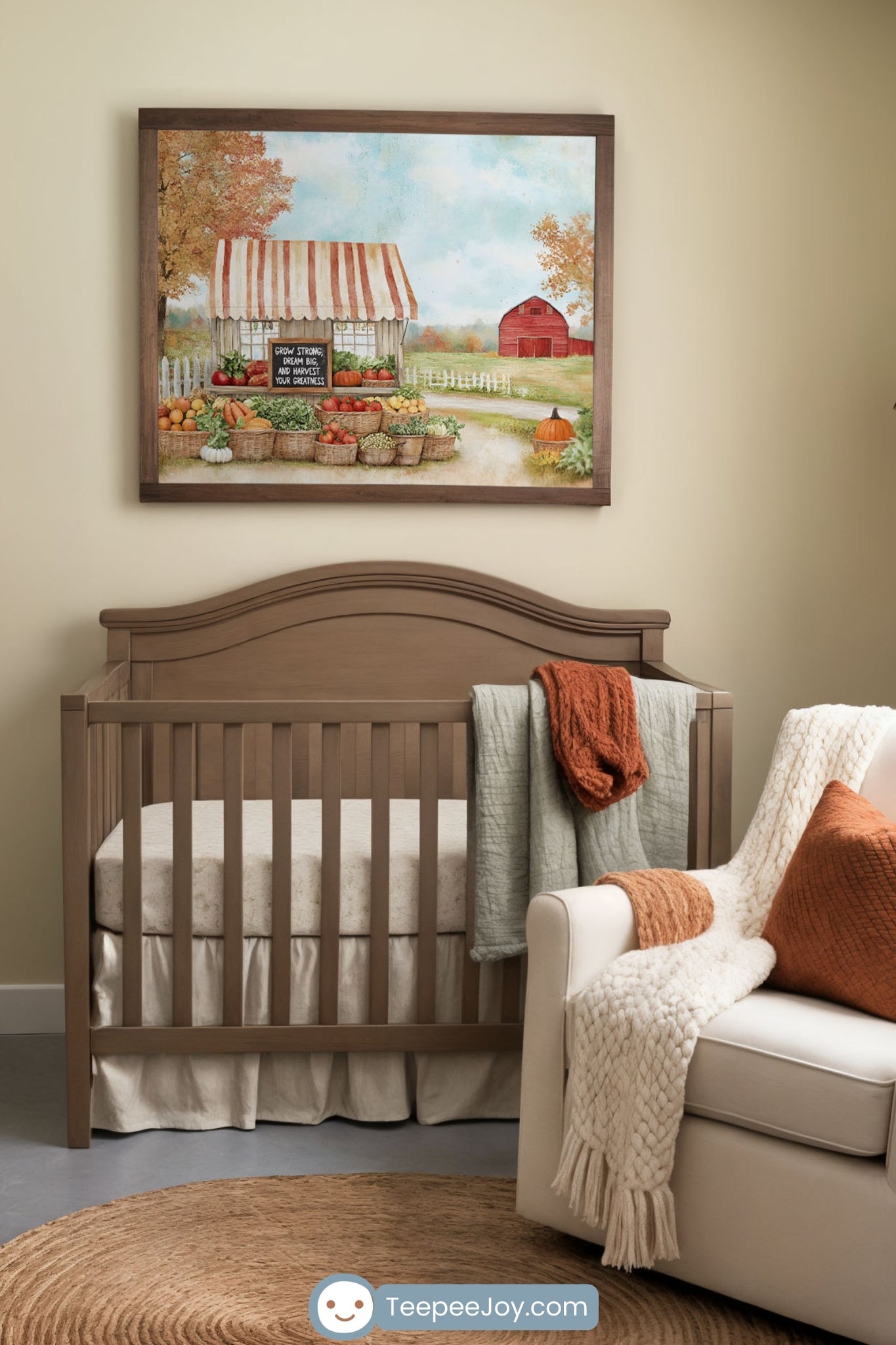 Warm and cozy farmhouse-style nursery with a wooden crib, a beige armchair, and a matching dresser with a changing pad. A framed painting of a rustic farm stand with fresh produce and a red barn hangs on the soft beige wall. Earthy tones, woven baskets, and textured blankets in burnt orange and cream add to the inviting, autumn-inspired aesthetic.