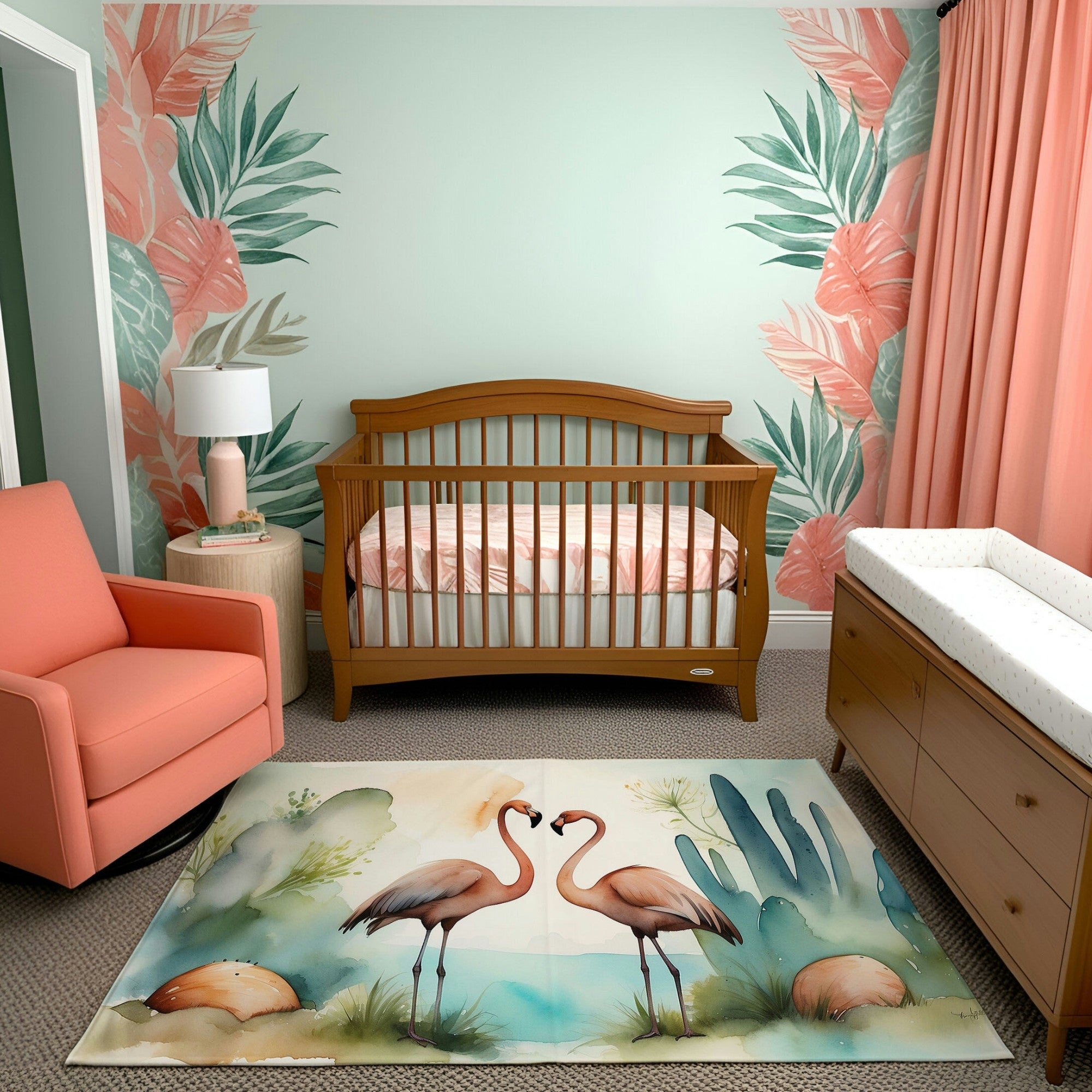 A cozy nursery decorated with tropical flair. The room features a wooden crib with a pink and white patterned sheet, a coral armchair, and matching coral curtains. A rug with a watercolor-style design of two flamingos surrounded by greenery and water adds charm, complemented by leafy wall art.