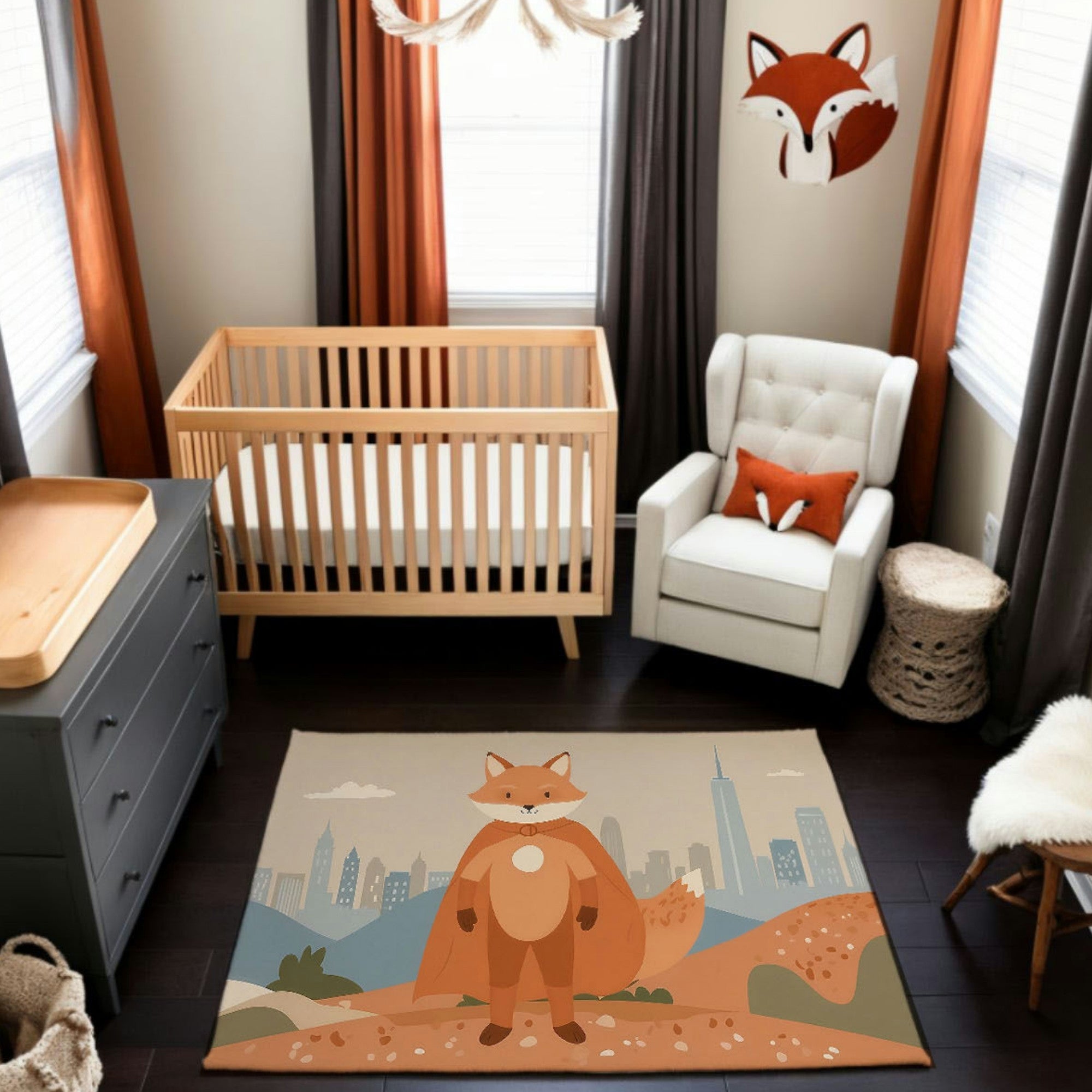 A cozy nursery with a wooden crib, gray dresser, and cream armchair, styled with orange and brown accents. The centerpiece rug depicts a superhero fox wearing a cape, standing proudly in a landscape with rolling hills and a city skyline in the distance, complementing the room's fox-themed decor.