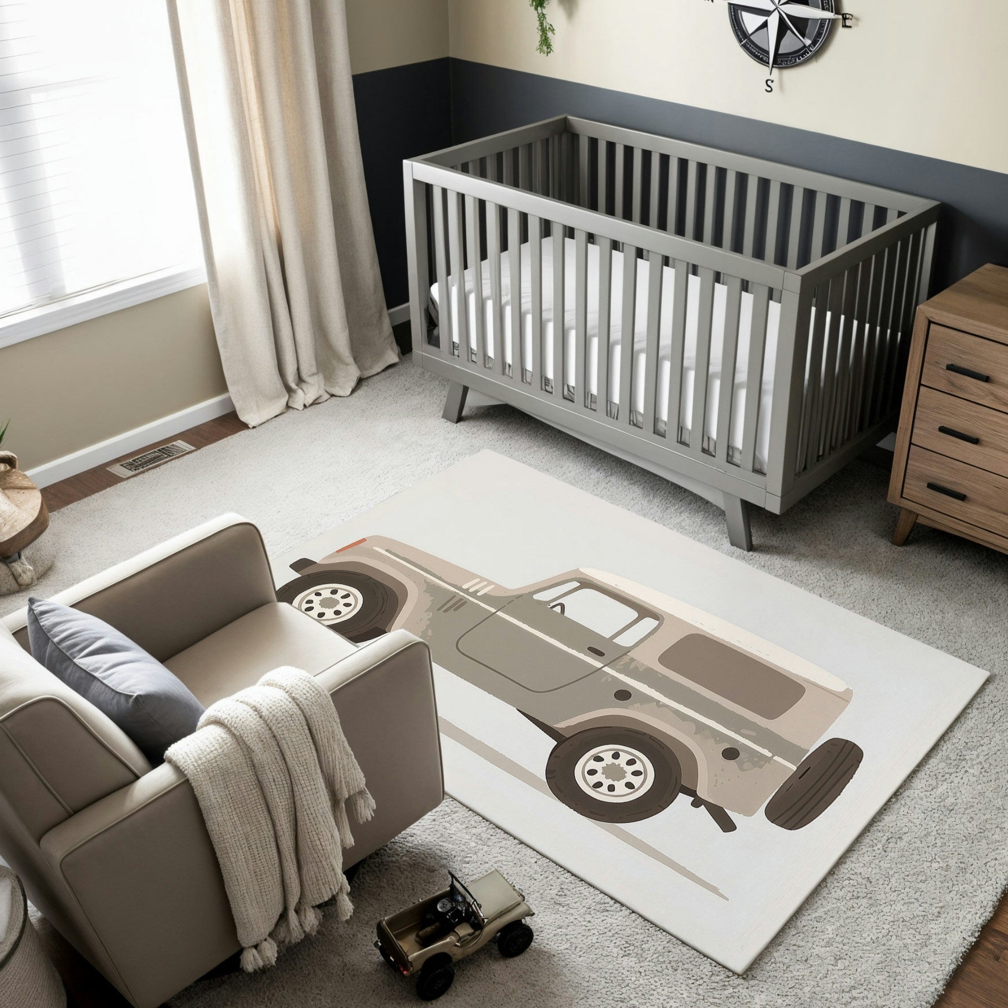 This nursery setup features a soft, neutral-toned rug with a graphic depiction of a rugged off-road vehicle, evoking adventure and exploration. The cozy, contemporary decor is complemented by the muted gray and beige color palette, with the jeep adding a playful, outdoorsy charm to the room. Perfect for a baby room with a theme of wanderlust or travel.