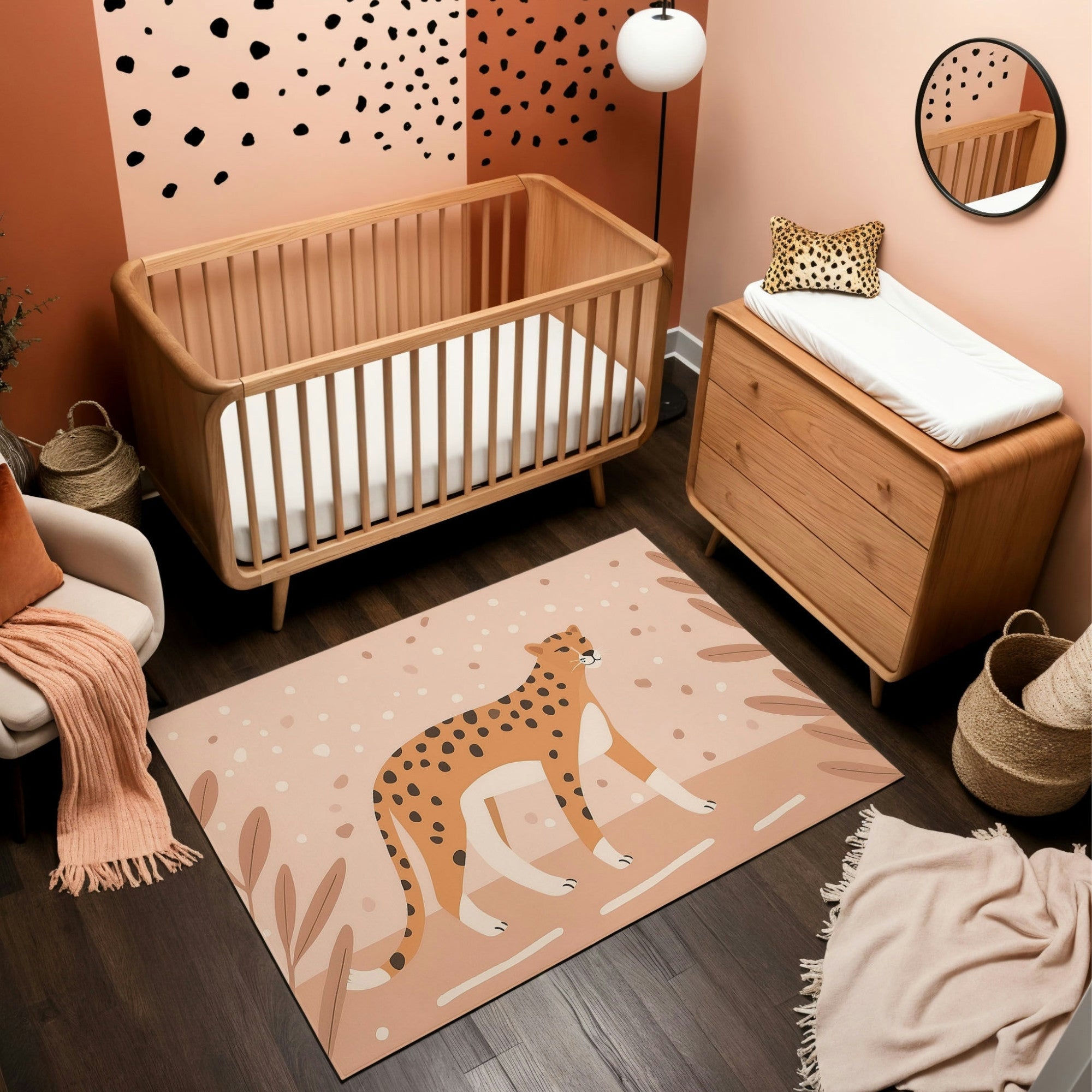 A safari-themed nursery featuring a natural wood crib and dresser, set against a warm peach and terracotta wall with black spotted accents. The room includes a soft area rug with a bold cheetah illustration, surrounded by minimalistic plant designs. A cozy white armchair with a peach blanket, woven baskets, and a cheetah-patterned pillow complete the playful and stylish decor.