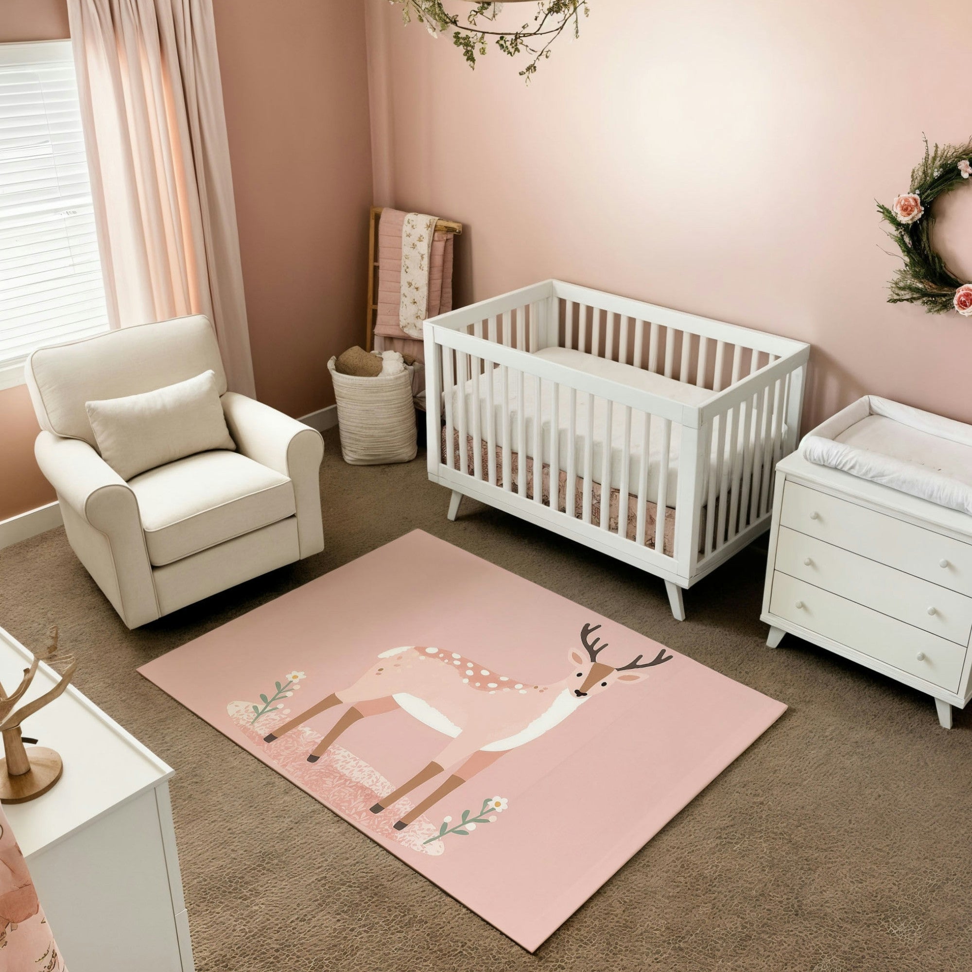 A soft pink nursery featuring a white crib and matching dresser, set against light pink walls decorated with a floral wreath. The room includes a comfortable armchair, a basket filled with blankets, and a wooden ladder for additional storage. The centerpiece is a pastel pink rug with an illustration of a gentle deer standing amidst small flowers, adding a charming and whimsical touch to the space.