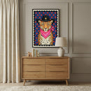 A framed illustration of a leopard wearing a black cowboy hat with a gold star and a bright pink bandana hangs above a modern wooden dresser. The room features elegant wall molding, neutral curtains, and a soft white rug.