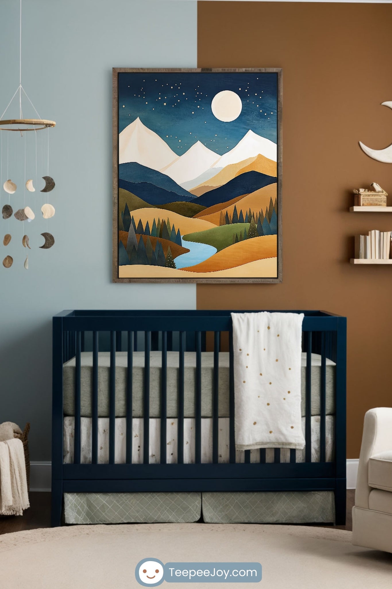 Cozy nursery with a nature-inspired theme, featuring a two-tone accent wall, a navy crib, and a framed mountain landscape artwork. A wooden dresser with a changing pad sits to the left, while a cream rocking chair with pillows is near the window. A crescent moon wall decor, floating shelves, and a celestial mobile add to the serene atmosphere.