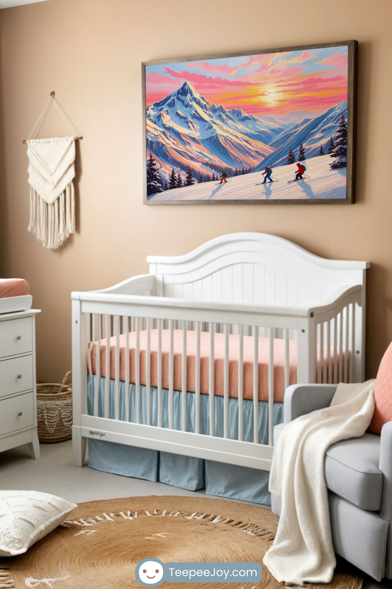 Cozy nursery featuring a white crib with soft peach and blue bedding, set against a warm beige wall. Above the crib hangs a framed painting of a snowy mountain scene with skiers at sunset, adding an adventurous touch to the space. A light gray armchair with a peach pillow and a draped knit blanket sits beside a woven basket with a potted plant. A white dresser with a matching changing pad, macramé wall decor, and floating shelves with winter-themed decorations complete the serene, outdoors-inspired design.