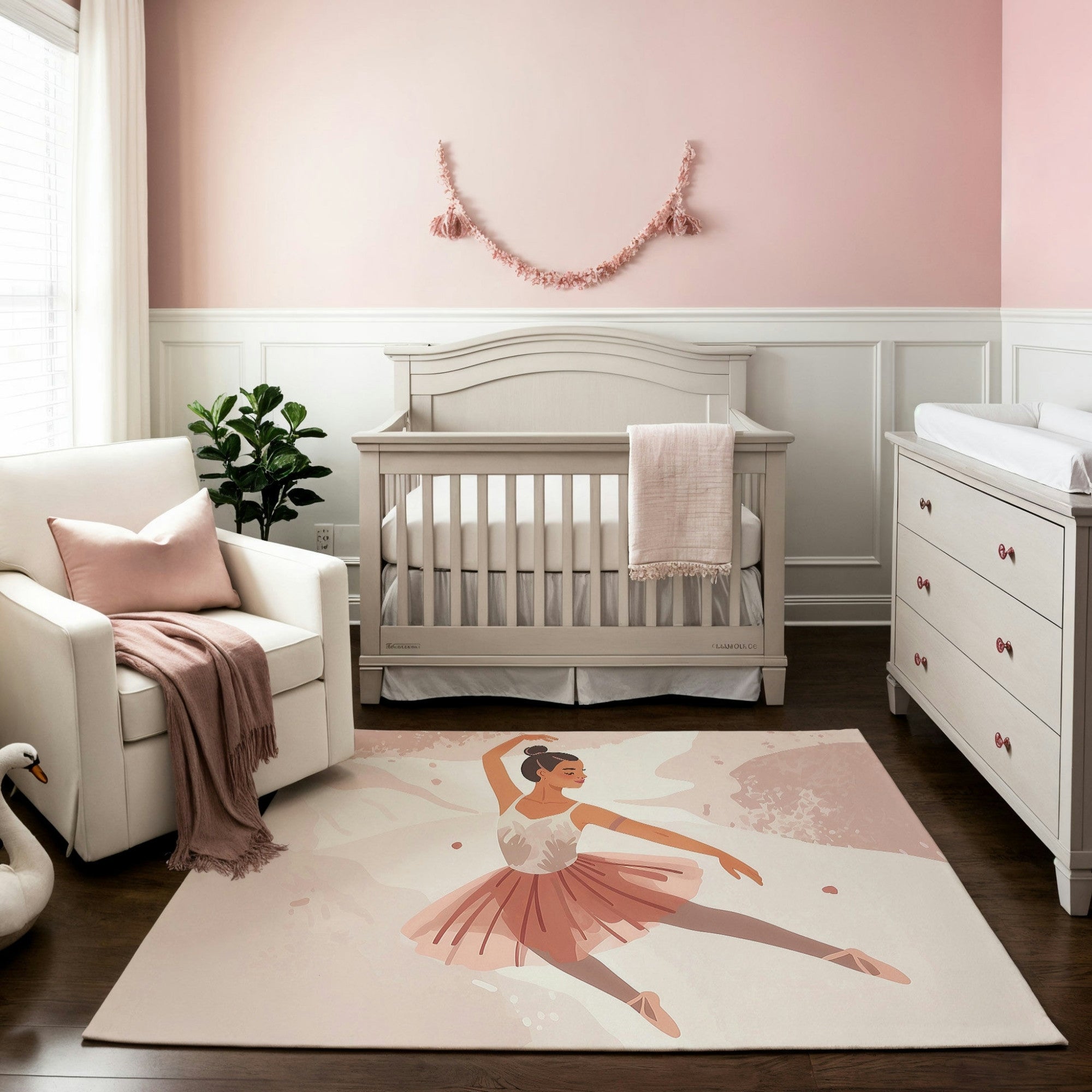 This nursery features a pastel-themed decor with a charming rug depicting a ballerina in a pink tutu gracefully dancing on a soft, textured background. The elegant and whimsical design complements the blush and cream color palette of the room, creating a soothing and stylish atmosphere.