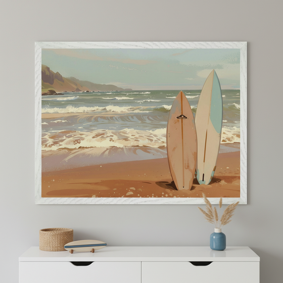 Modern room with a white dresser. A large white-framed painted beach scene with two surfboards stands centered above the dresser. A woven basket, a small surfboard decoration, and pampas grass in a blue vase are on the dresser.