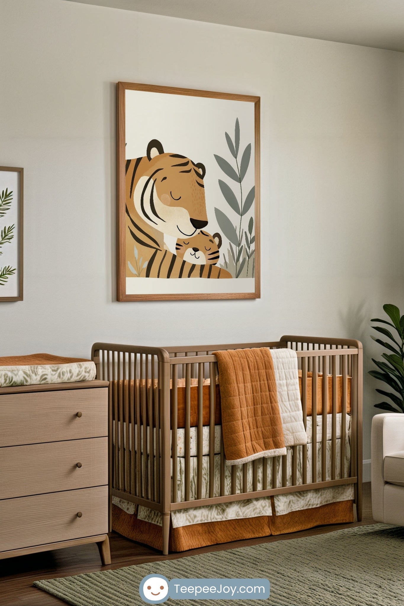 Calming nursery with earthy tones featuring a wooden crib dressed in rust orange and sage green bedding, complemented by a sweet wall art of a parent tiger snuggling a tiger cub among soft greenery. The cozy setup includes a matching changing table and natural accents for a warm, jungle-inspired vibe.