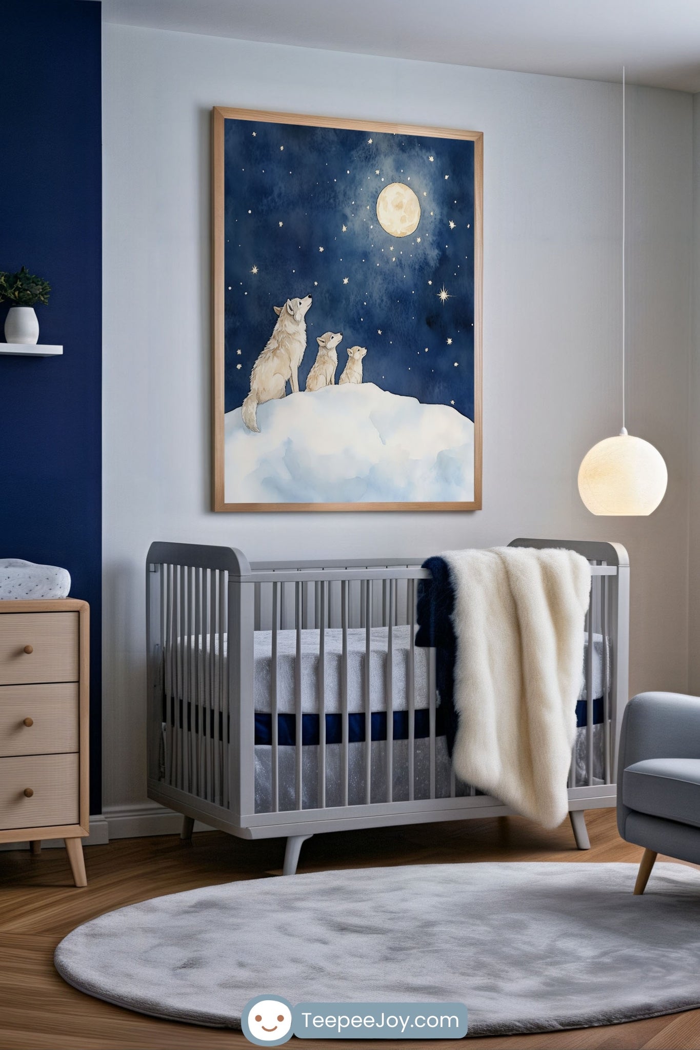 Moonlit nursery featuring framed artwork of three wolves standing on a snowy hill, gazing up at a glowing full moon in a deep starry night sky. The space includes a gray crib with soft gray and navy bedding, a plush faux fur blanket, a round light-gray rug, and modern wooden furniture.