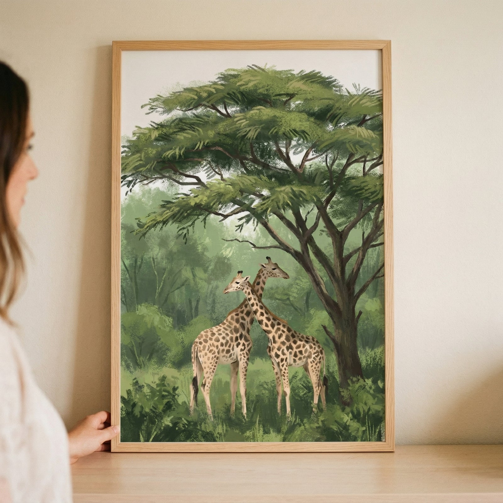 Acacia tree canopy giraffe wall art in a wooden frame, featuring two giraffes standing under a large green tree.