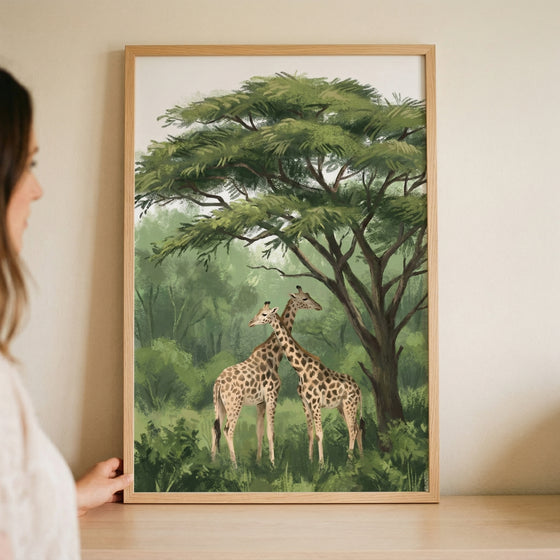 Acacia tree canopy giraffe wall art in a wooden frame, featuring two giraffes standing under a large green tree.