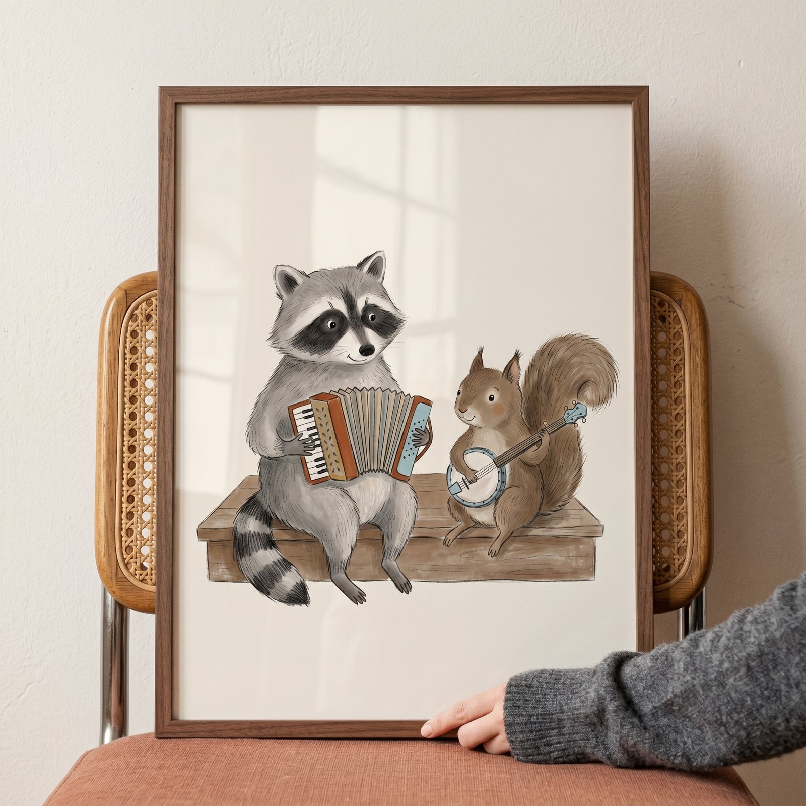 Accordion raccoon banjo squirrel animals wall art in a wood frame shows a raccoon and squirrel playing music on a bench.
