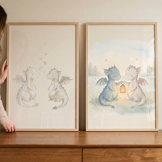 Adorable watercolor baby dragons wall art set of 2 featuring dragons with hearts and others holding a glowing lantern.