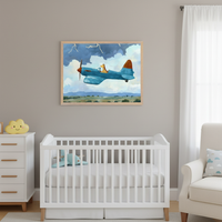 Modern nursery with a white crib and matching dresser. A light wood-framed print of a blue plane piloted by a giraffe, flying through stormy clouds over green hills, hangs centered above the crib. A cream armchair is on the right.
