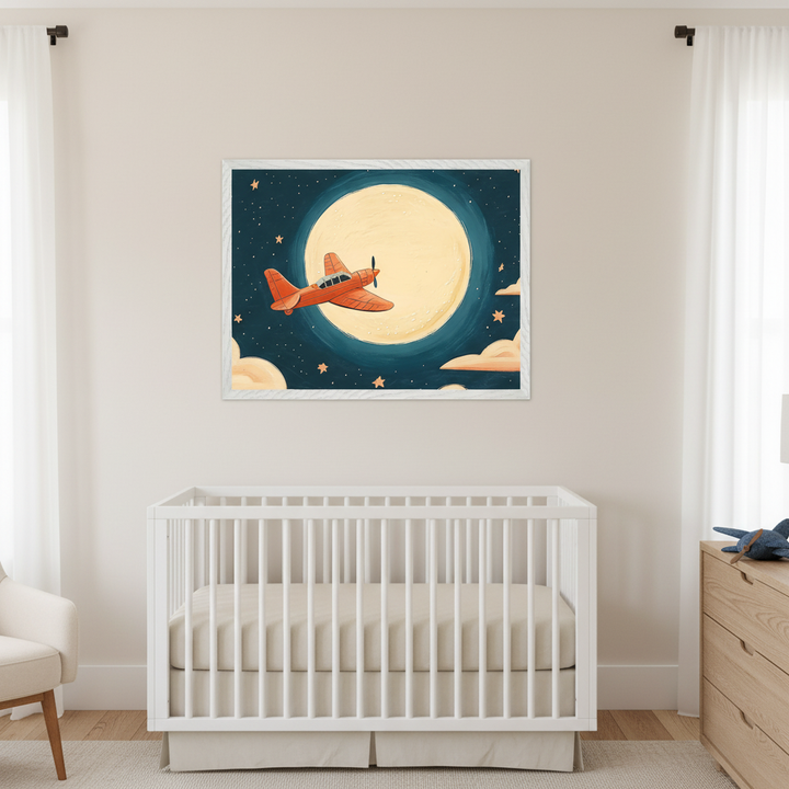 Modern nursery with a white crib and beige bedding. A large framed print of an orange propeller airplane flying under a bright full moon in a starry night sky hangs centered above the crib. A wooden dresser is on the right, and a white armchair is on the left.
