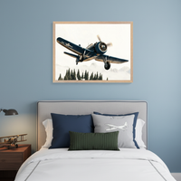 Modern kid's bedroom with a bed featuring a gray upholstered headboard. A large framed print of a vintage blue propeller airplane flying over a forest and misty mountains hangs above the bed on a blue wall. A nightstand with a lamp and airplane model is to the left.