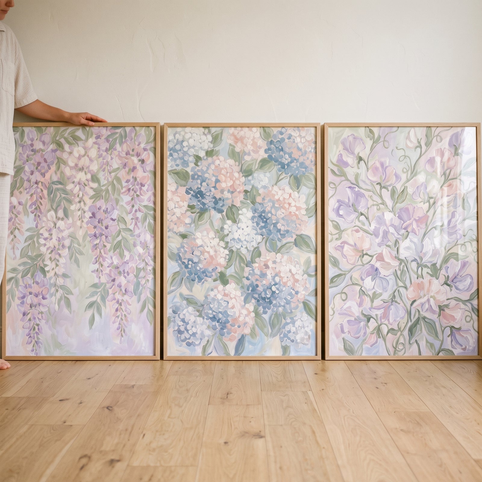 Airy pastel botanical floral wall art set of 3 in wooden frames featuring wisteria, hydrangeas, and sweet peas.