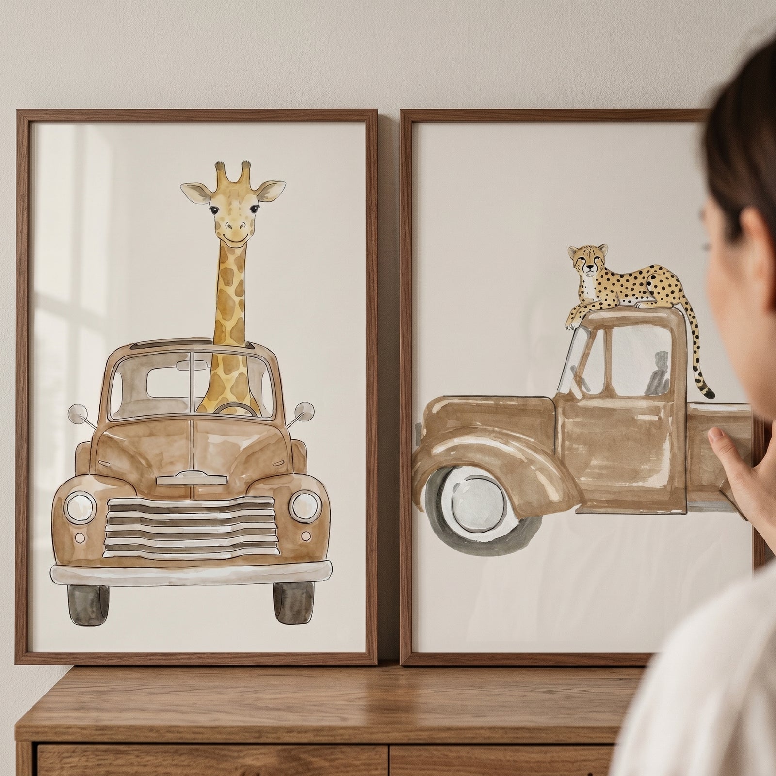 Framed antique brown truck animal wall art set of 2 featuring a giraffe and a cheetah on a wooden dresser.