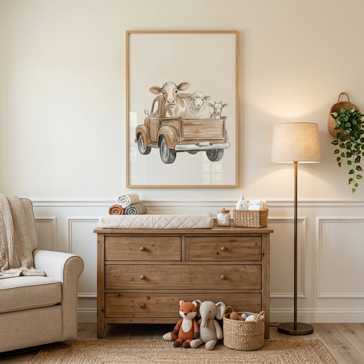 Antique truck farm animal wall art hangs in a neutral nursery with a wood dresser, armchair, floor lamp, and plush toys.