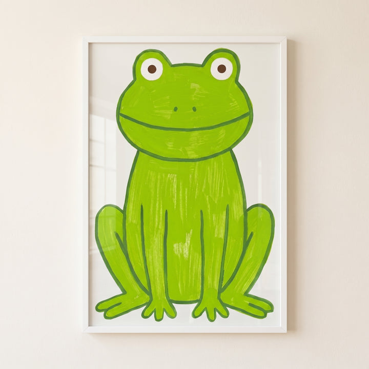 Apple green textured frog wall art features a front-facing, smiling green frog with brown eyes in a white frame.