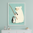 Modern kid's room with a light teal wall. A white-framed whimsical illustration of a polar bear fishing with two penguins hangs centered above a white dresser.